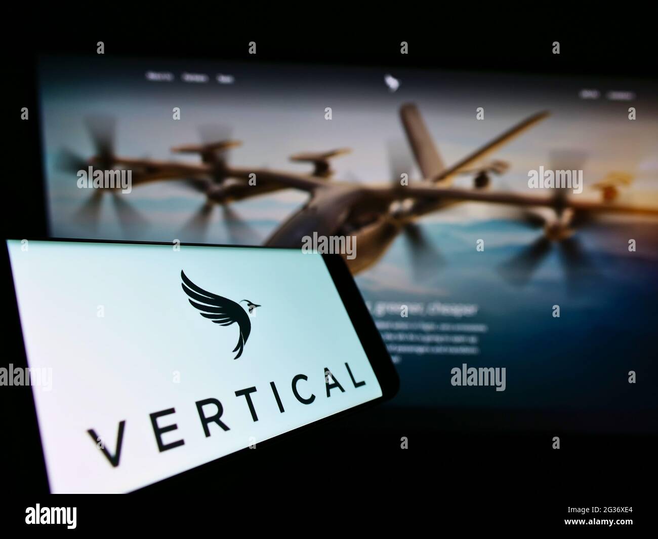 Cellphone with logo of British aircraft company Vertical Aerospace Ltd. on screen in front of website. Focus on center-right of phone display. Stock Photo