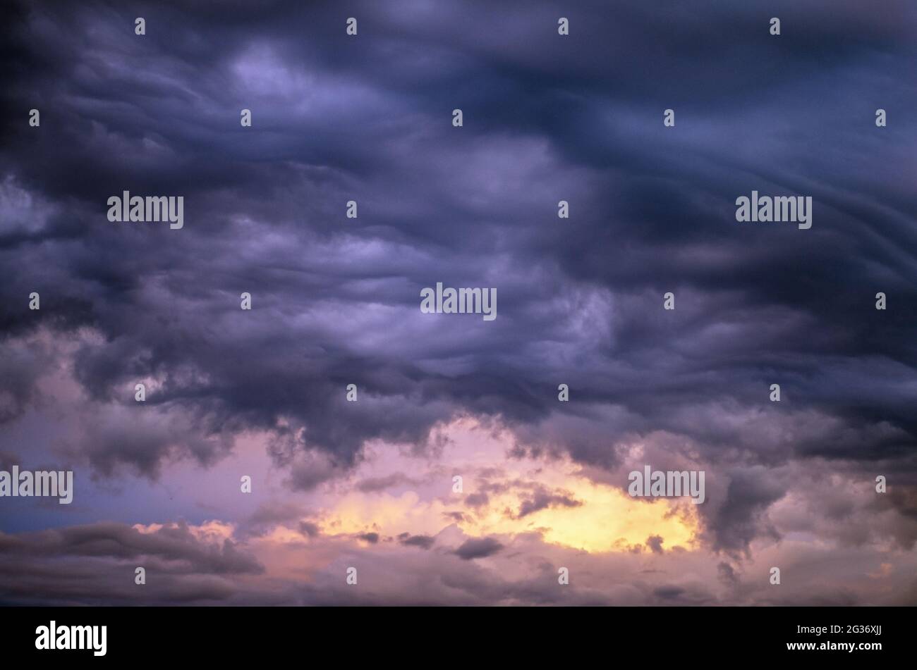 Sunset sky with heavy clouds-altocumulus undulatus asperitas.cloudy landscape Stock Photo