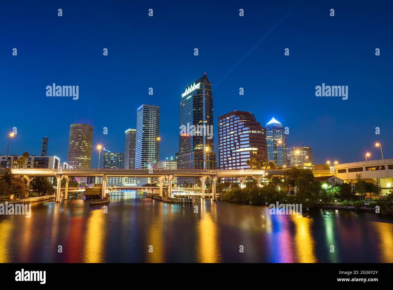 Tampa skyline at night with Hillsborough river in the foreground Stock Photo