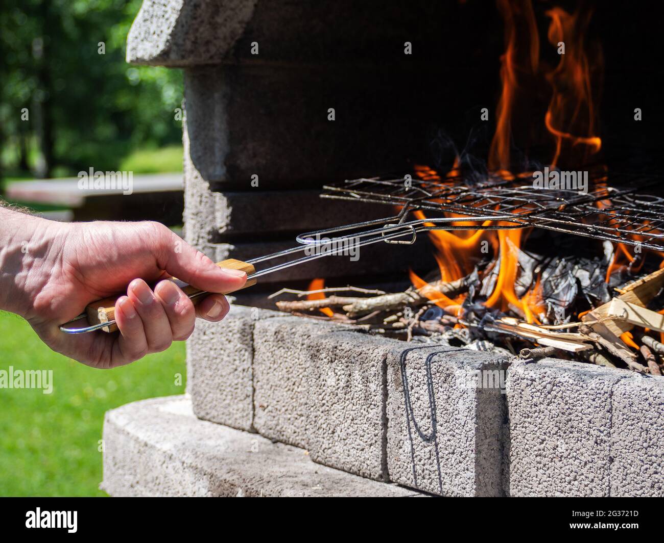 Daytime outdoor stone barbecue preparation Stock Photo