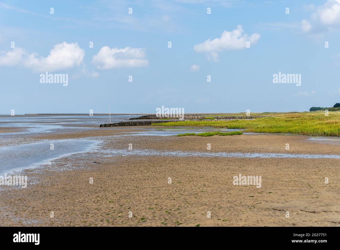 The Beach of Cuxhaven on low tide. The Wadden Sea is an intertidal zone in  the southeastern part of the North Sea forming a shallow body of water with  Stock Photo -