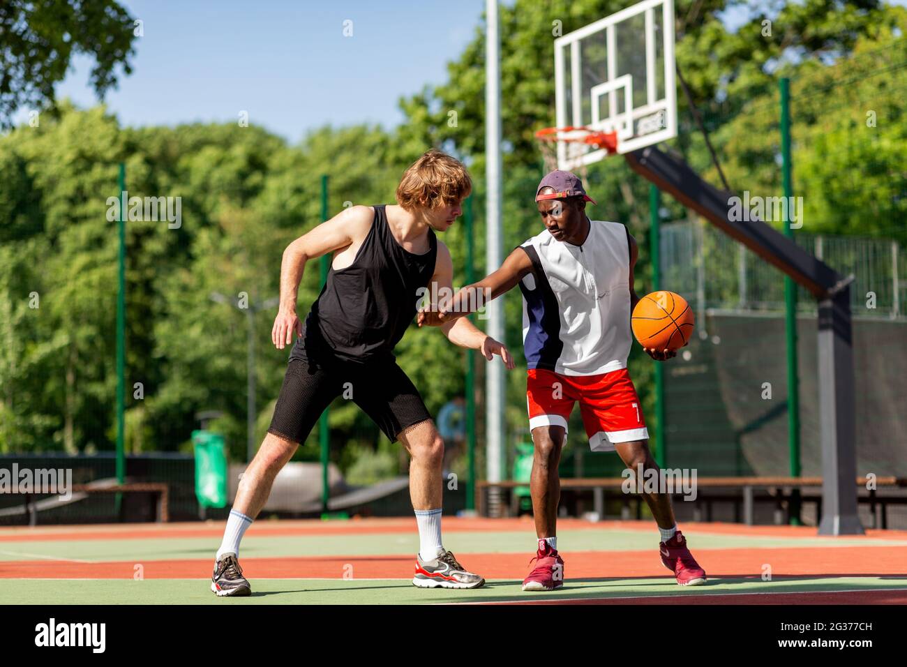 Two professional basketball players training for competition at outdoor court Stock Photo