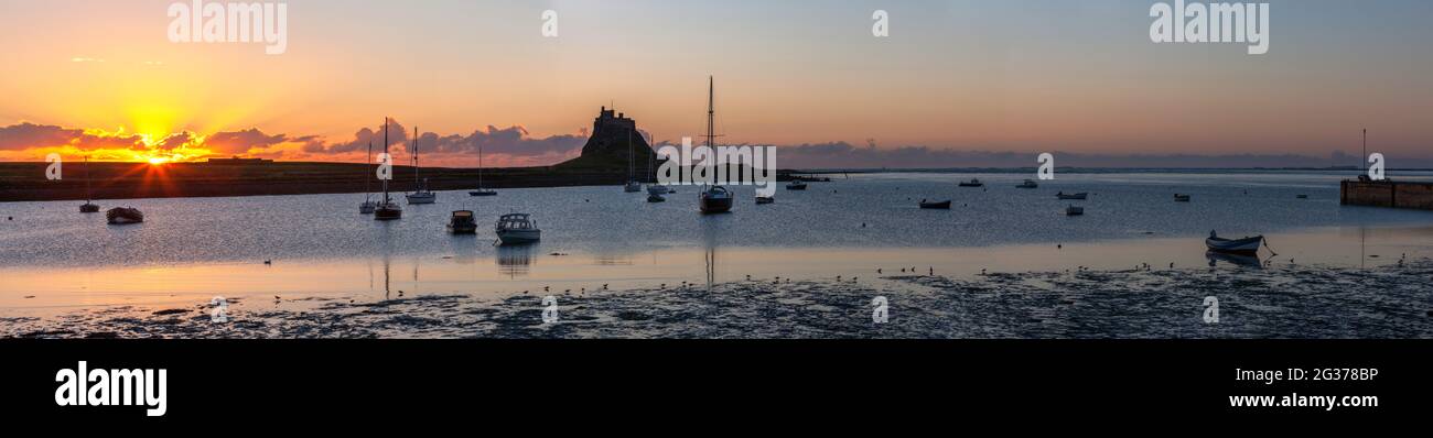 Panoramic view of Lindisfarne Castle and harbour at dawn, Holy Island, Northumberland, England, United Kingdom Stock Photo