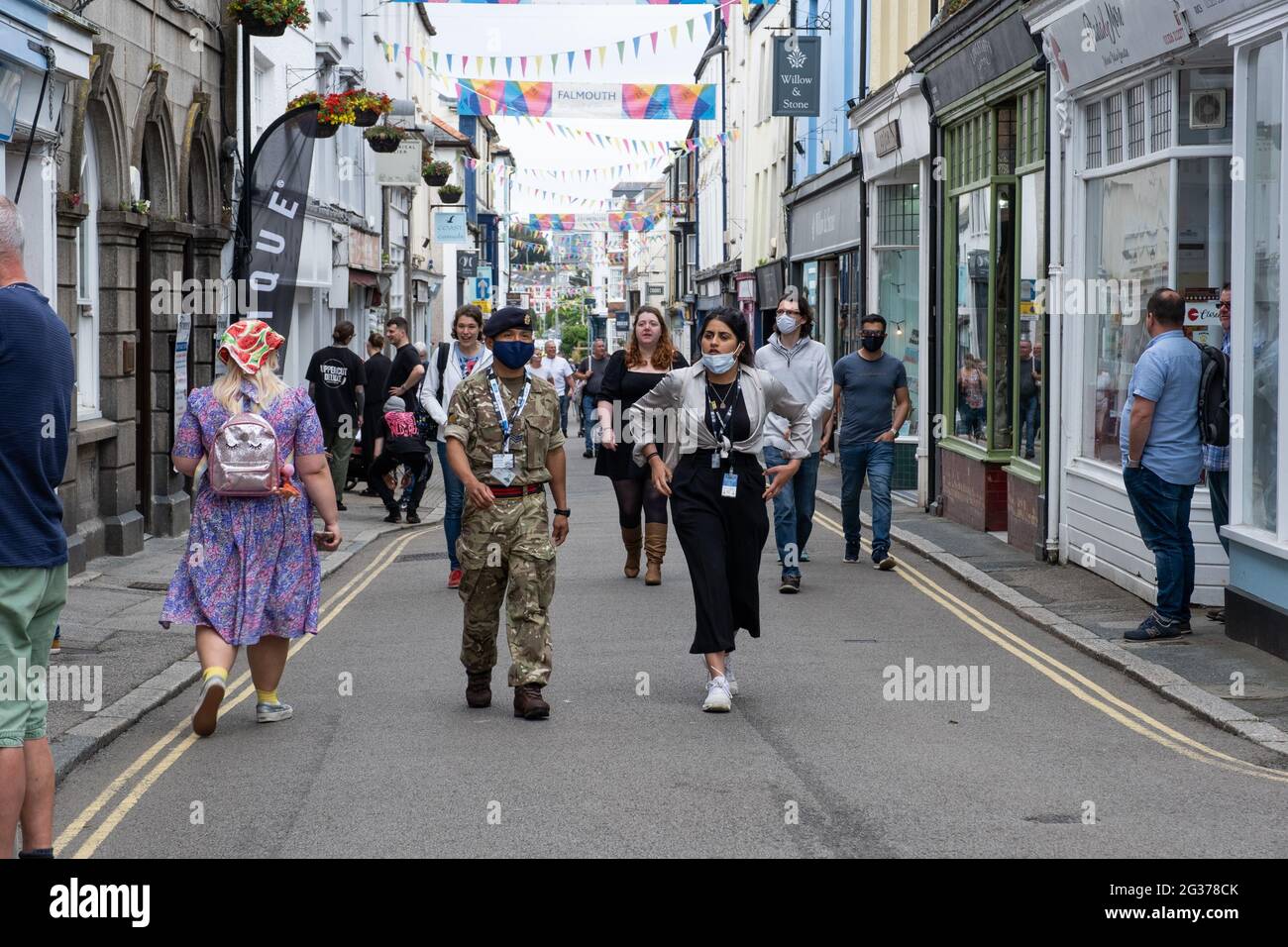 Uniformed Gurkha soldier walking up Falmouth's Main Street as part of the team involved with the G7 summit on Climate Change. Other people around. Stock Photo