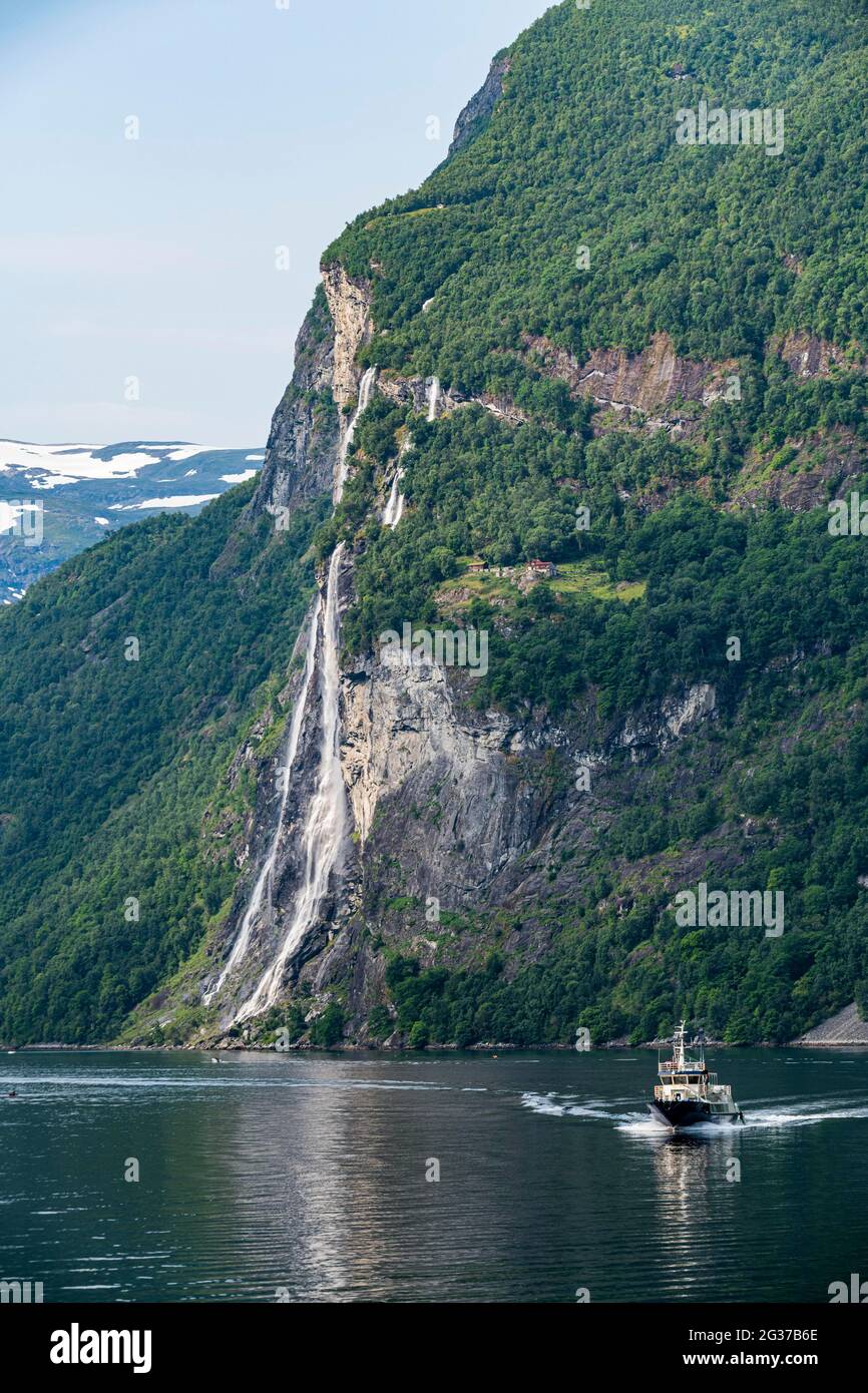 Ferry boat before a waterfall in Geirangerfjord, Sunmore, Norway Stock ...