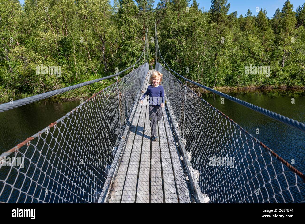 Young girl on a steel bridge, on the road to the Nordkapp, Norway Stock Photo
