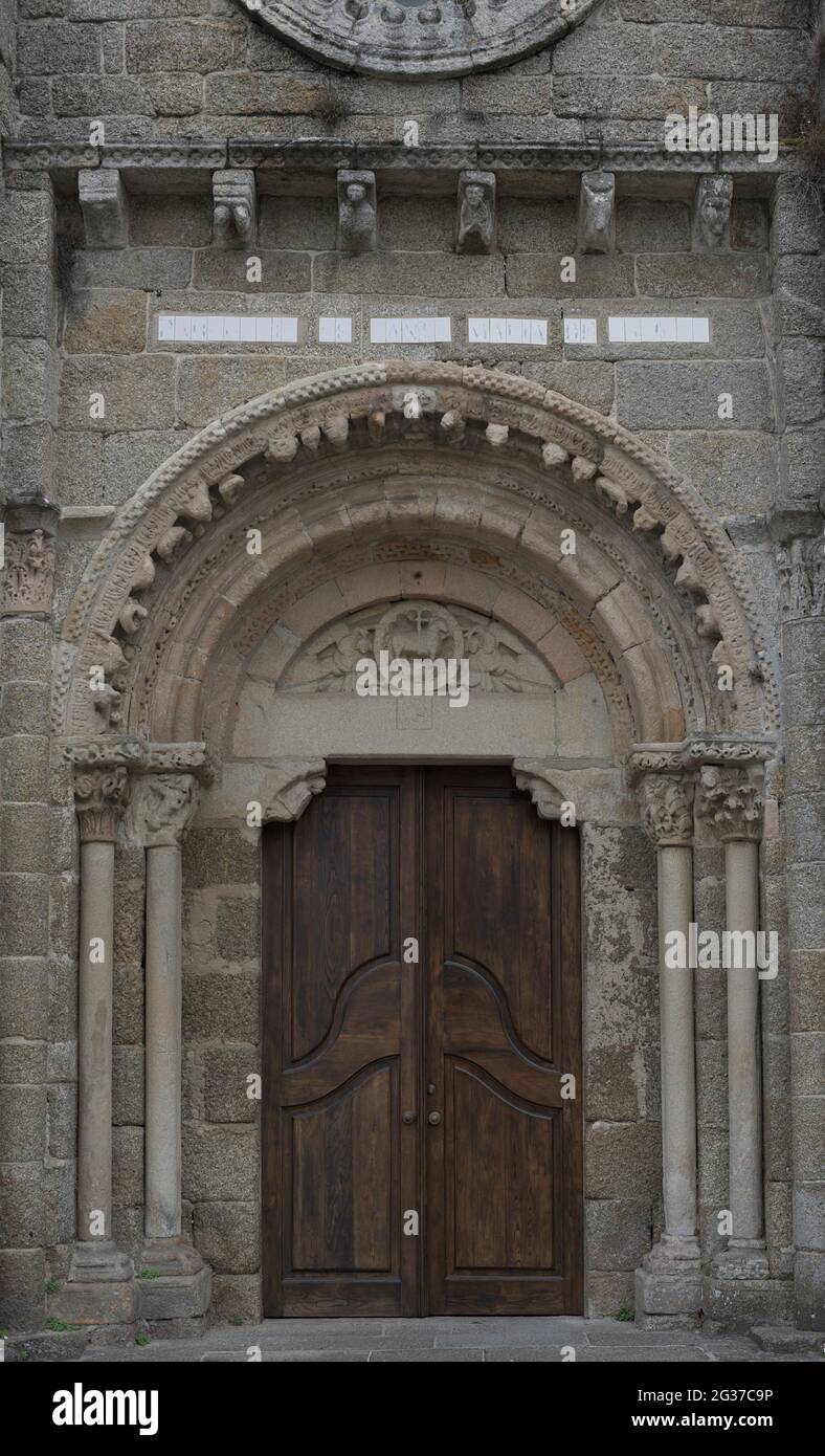 Spain, Galicia, La Coruña province, Cambre. Church of Santa Maria. Built in the 12th century in Romanesque style. Architectural detail of the doorway of the main facade. The Agnus Dei is depicted in the tympanum. Stock Photo