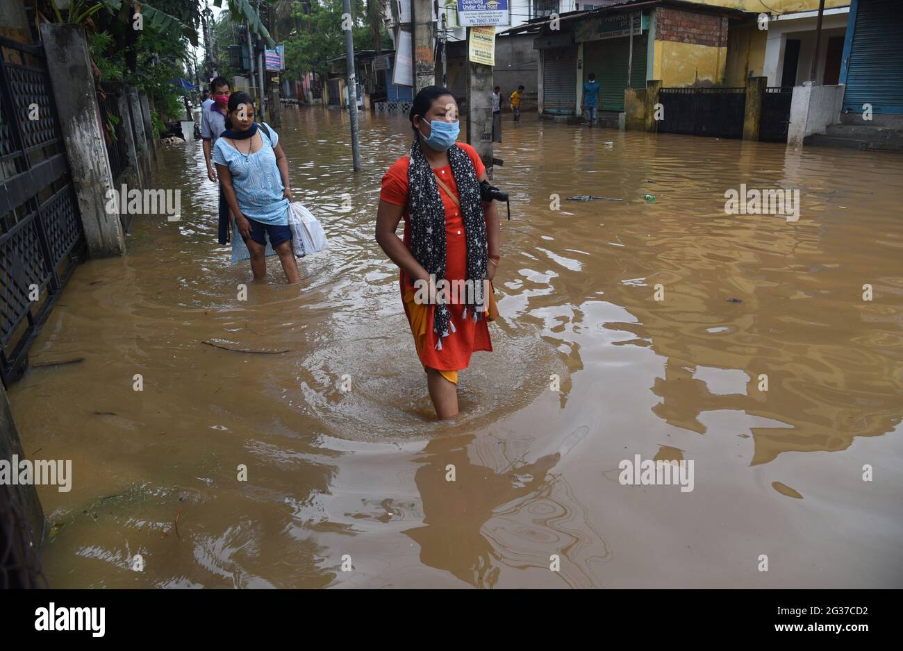 Guwahati, Guwahati, India. 14th June, 2021. Women wades through the