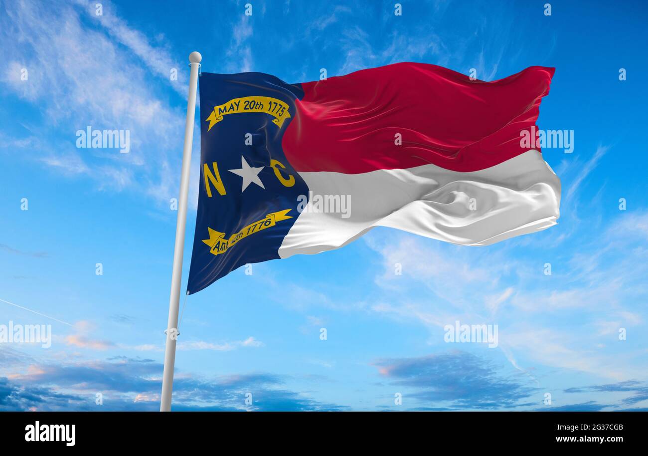 flag of North Carolina at cloudy sky background on sunset. Patriotic ...
