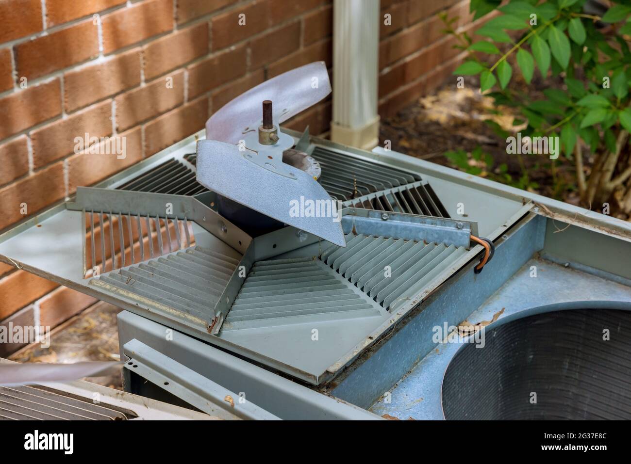 Technical home service with dirty clogged air conditioner condenser cooling fins Stock Photo