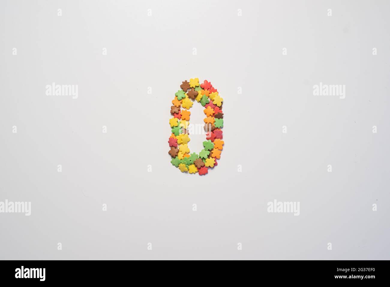 Numeral zero from sweet pastry topping in the form of colorful foliage ...