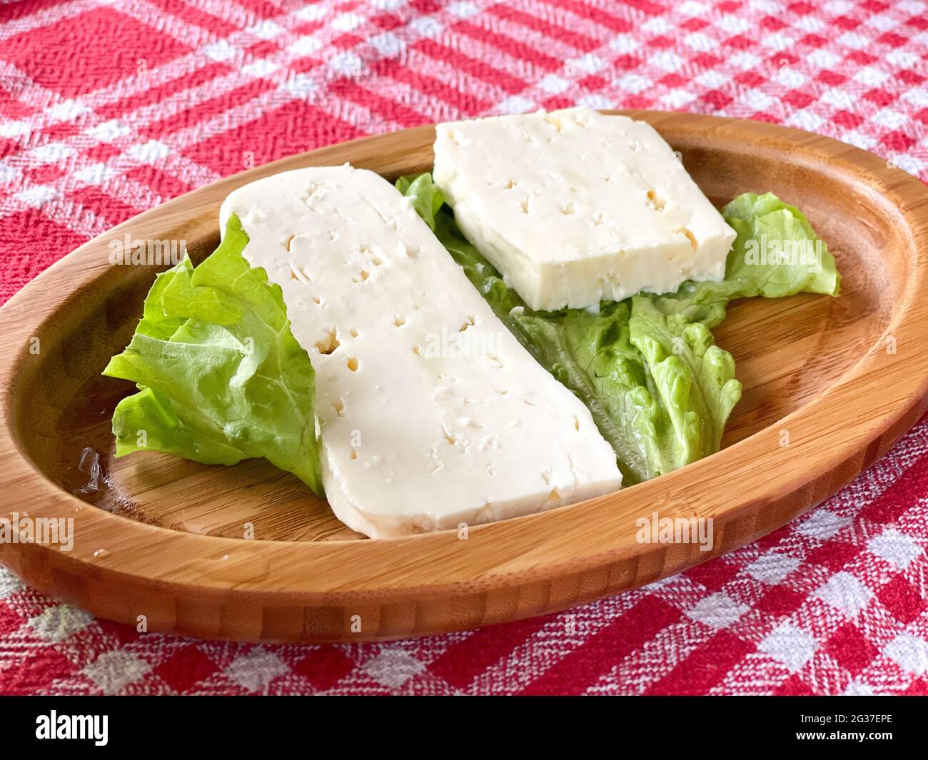 White cheese on a wooden plate. Food ang drinks.  Stock Photo