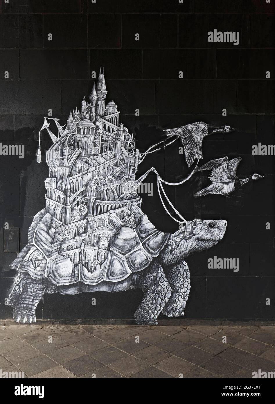 Paste up, turtle carries machine city on shell, symbol for balance of nature and technology, surreal picture, mechanimal by streetart artist Ardif Stock Photo