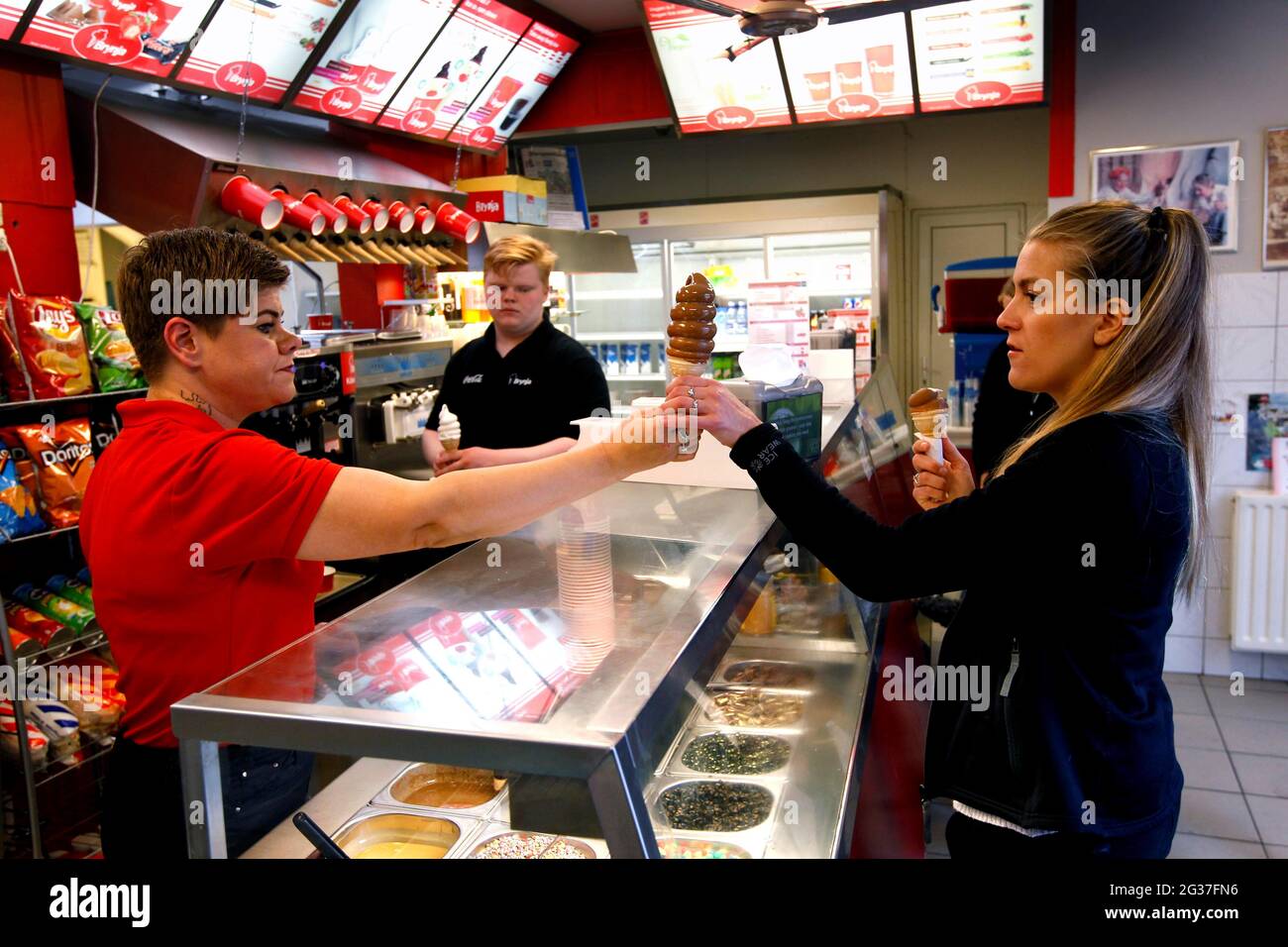 Ice cream vendor selling ice cream cone to customer, Brynja ice cream