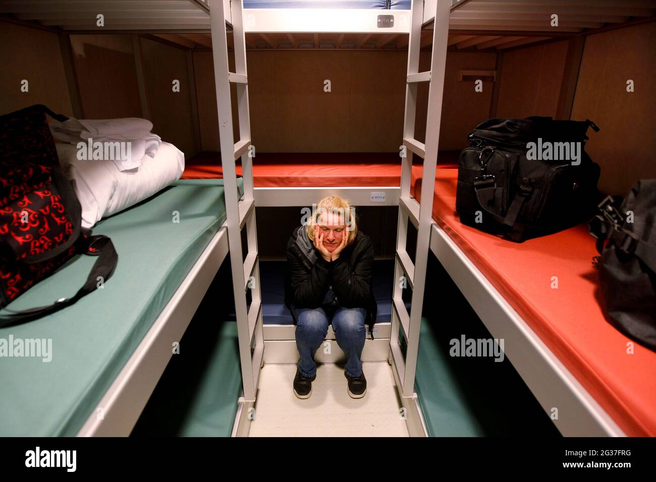 Denmark and Faeroer ferry Norroena, Smyril Line ship, cabin, woman between bunk beds, Seyoisfjoerour, Iceland Stock Photo