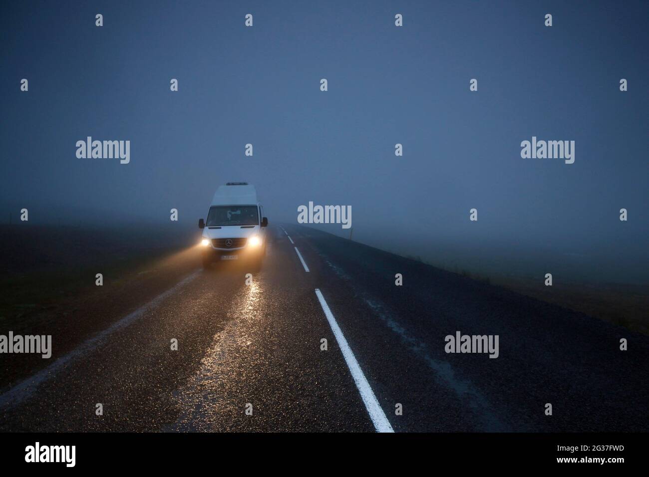 Ring road, N1, asphalt road, Mercedes Sprinter camper, camper van, fog, headlights, Iceland Stock Photo