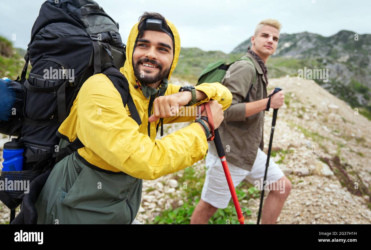 Group of fit healthy friends trekking in the mountains Stock Photo - Alamy