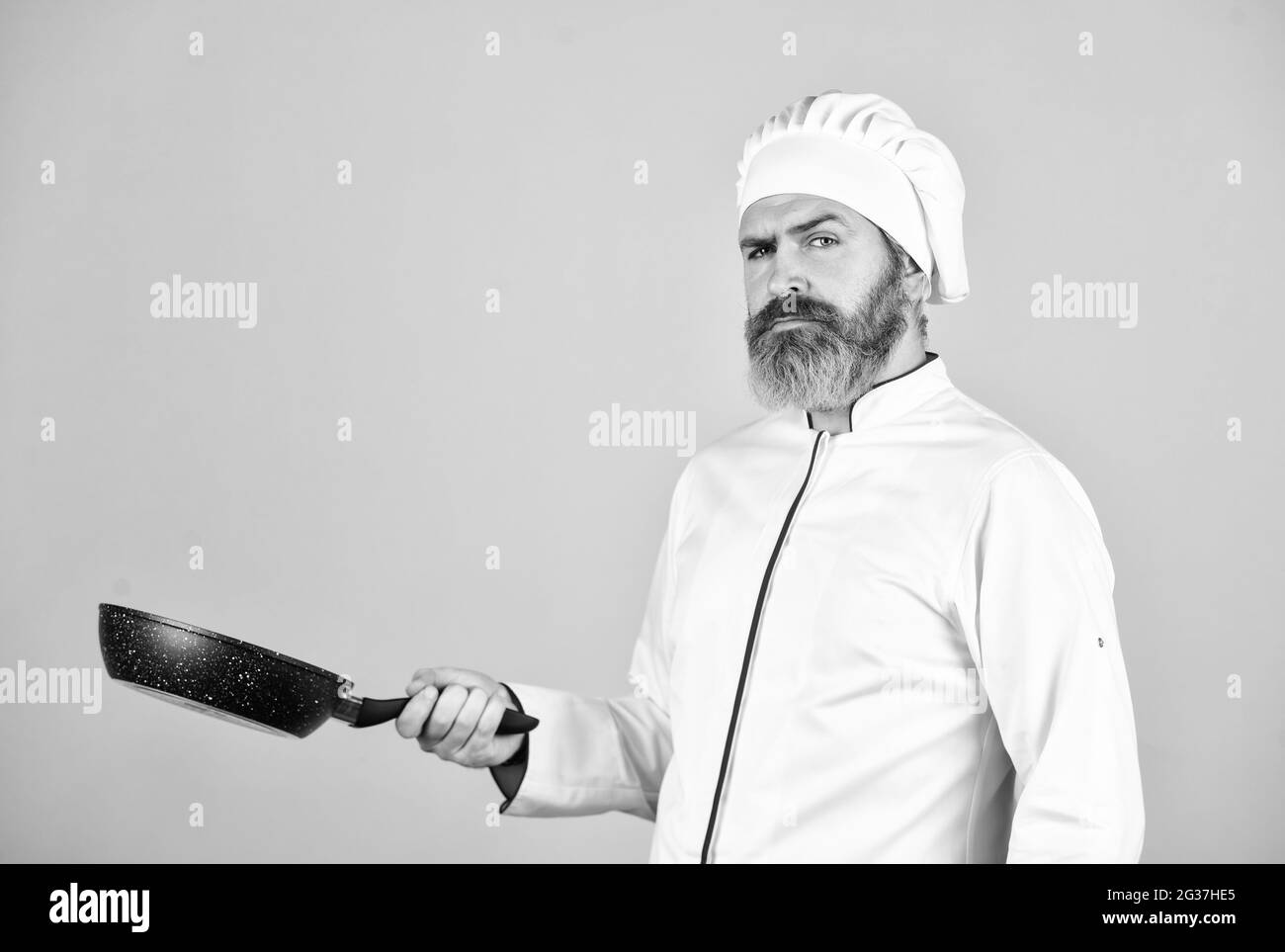 Healthy food. Man hold pan. Frying meal. Bearded chef preparing breakfast. Frying without oil