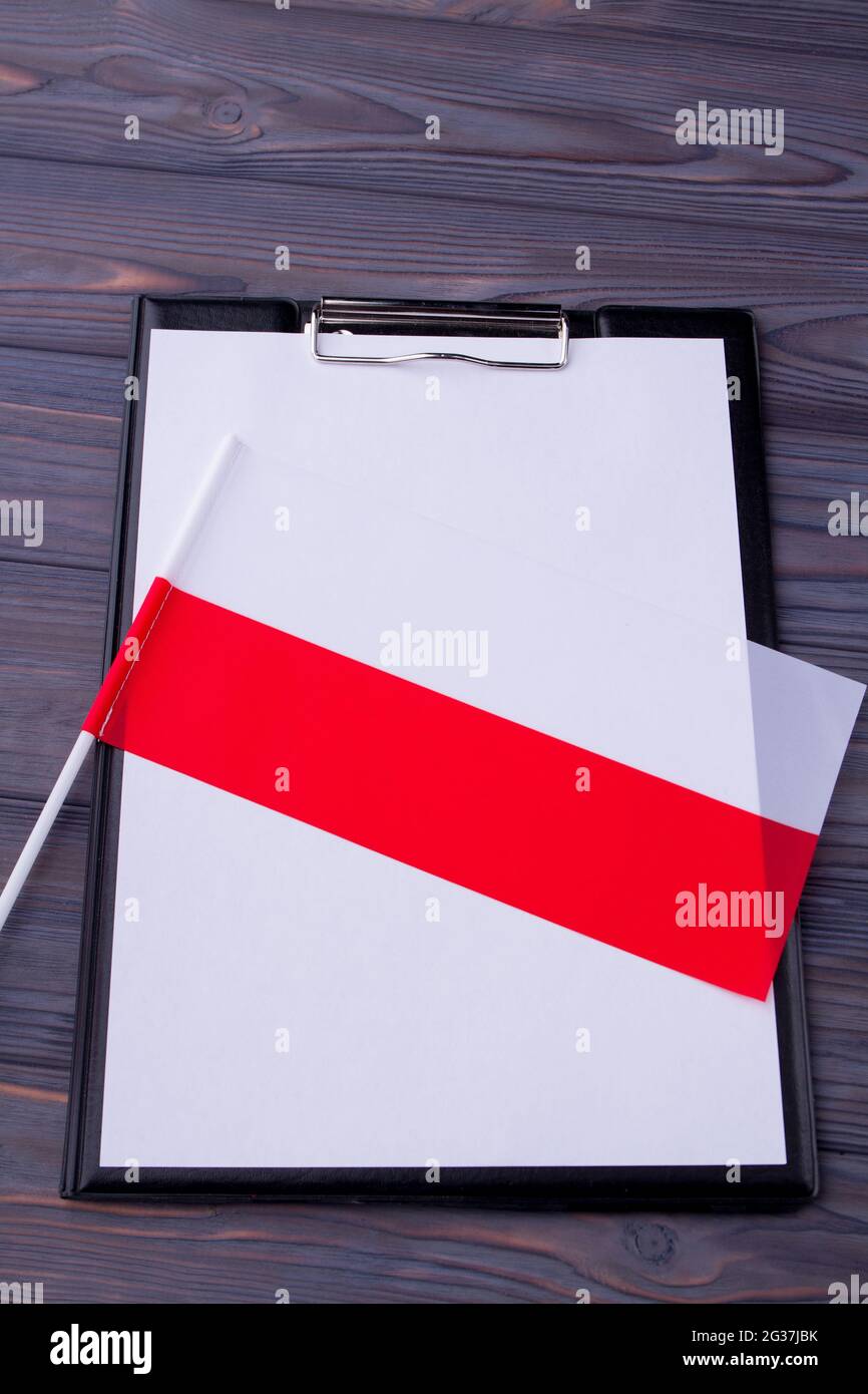 Clipboard with blank paper and bicolored flag of Poland. Stock Photo