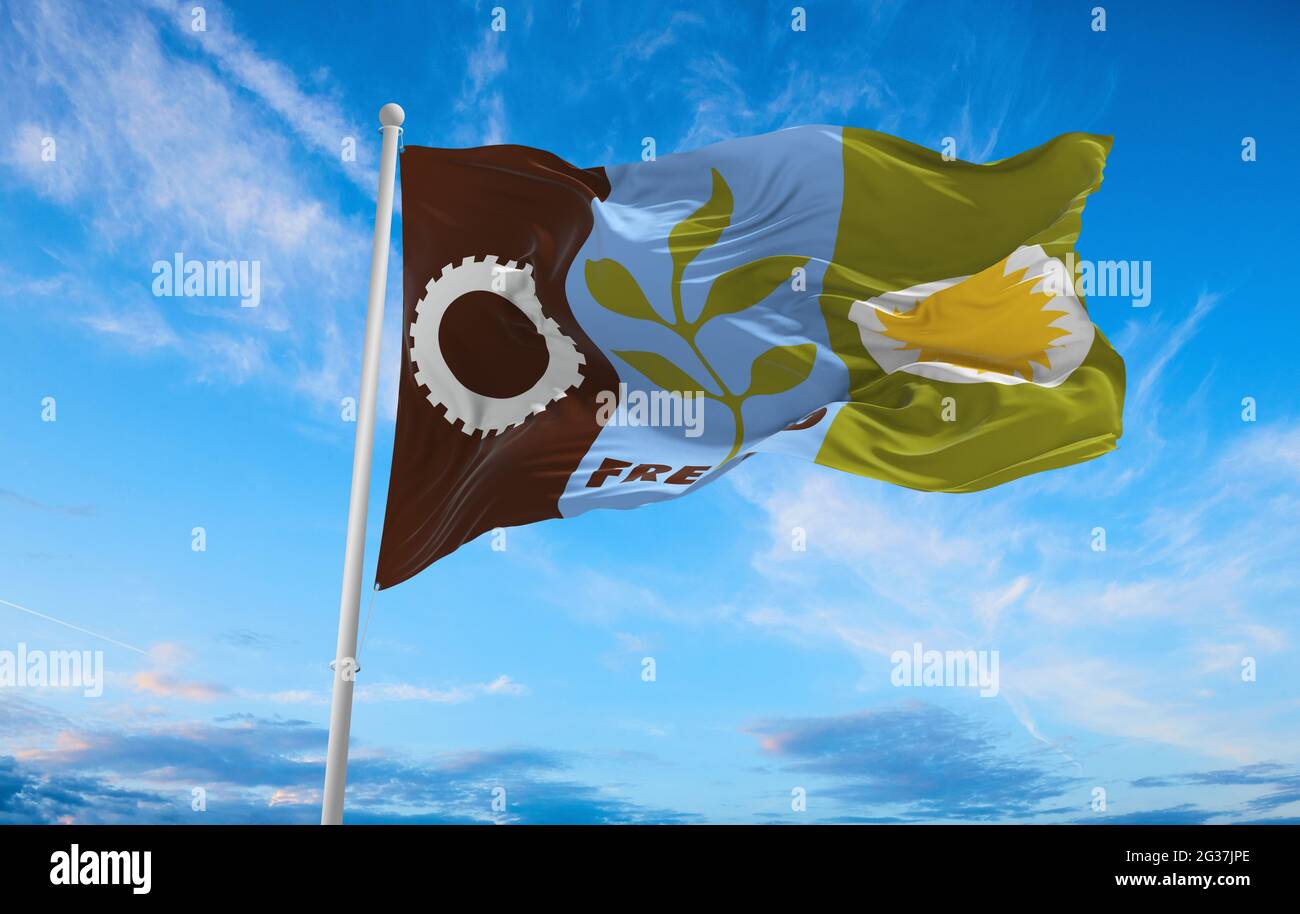 flag of Fresno, California at cloudy sky background on sunset