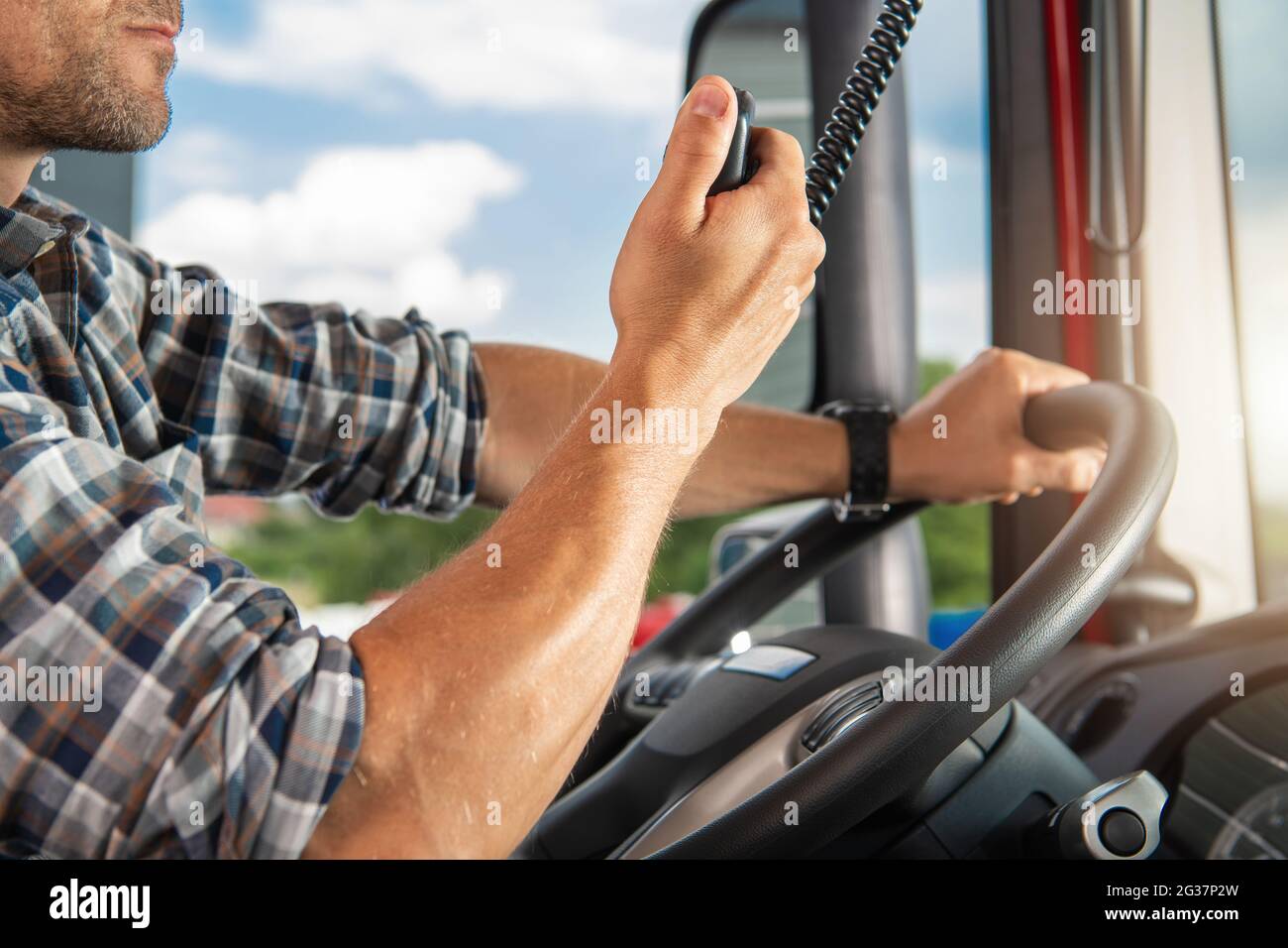 Semi Truck Driver Talking on CB Radio. Citizen Bands Radio Inside the