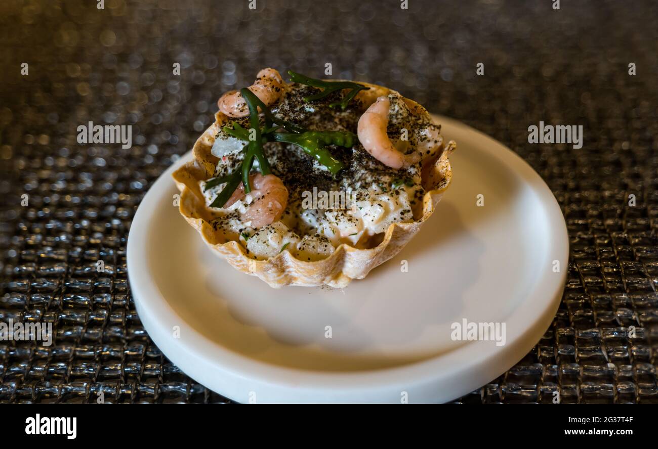 Shellfish pastry tart served as starter, canape or hors d'oeuvre in a fine dining restaurant Stock Photo