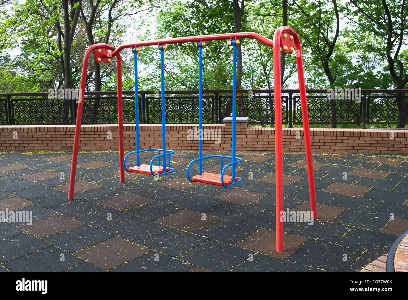 Two child swings in empty playground due coronavirus. Safety for children.  Baby swings metal. Injury due to a fall Stock Photo - Alamy