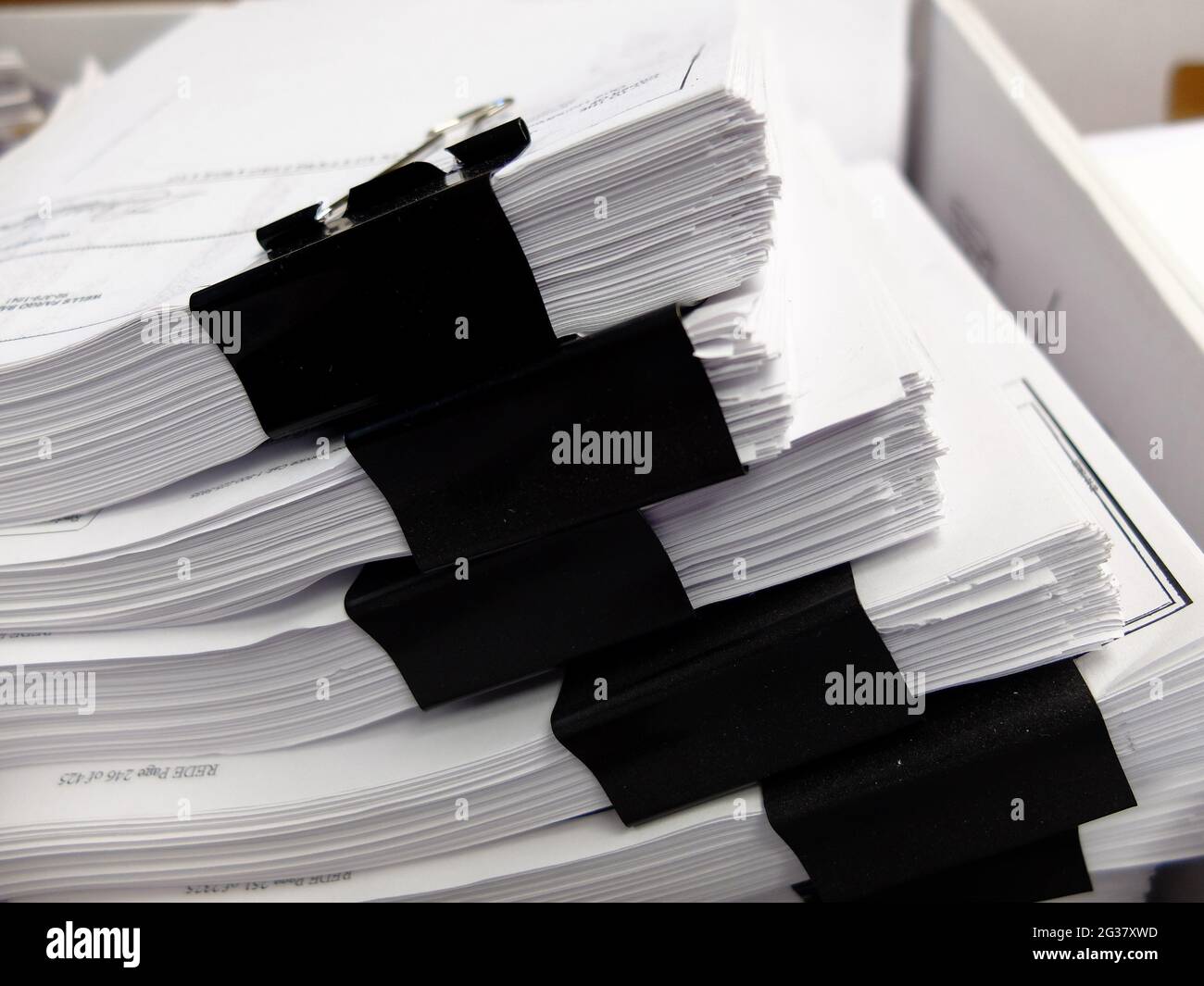 Stacks of documents with black clips in box for filing business legal education Stock Photo