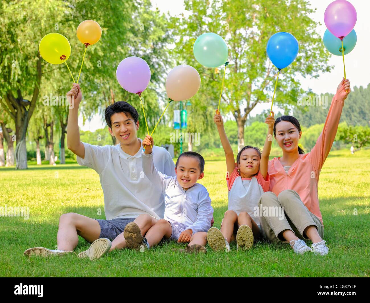 Happy family of four in the park high quality photo Stock Photo - Alamy