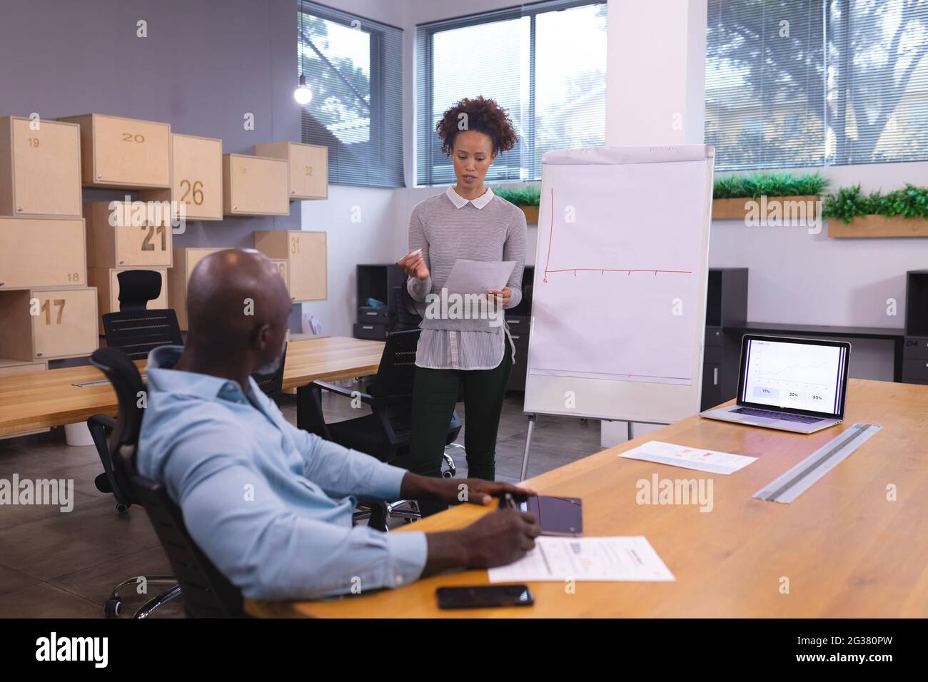 Two diverse female colleagues discussing hi-res stock photography and ...