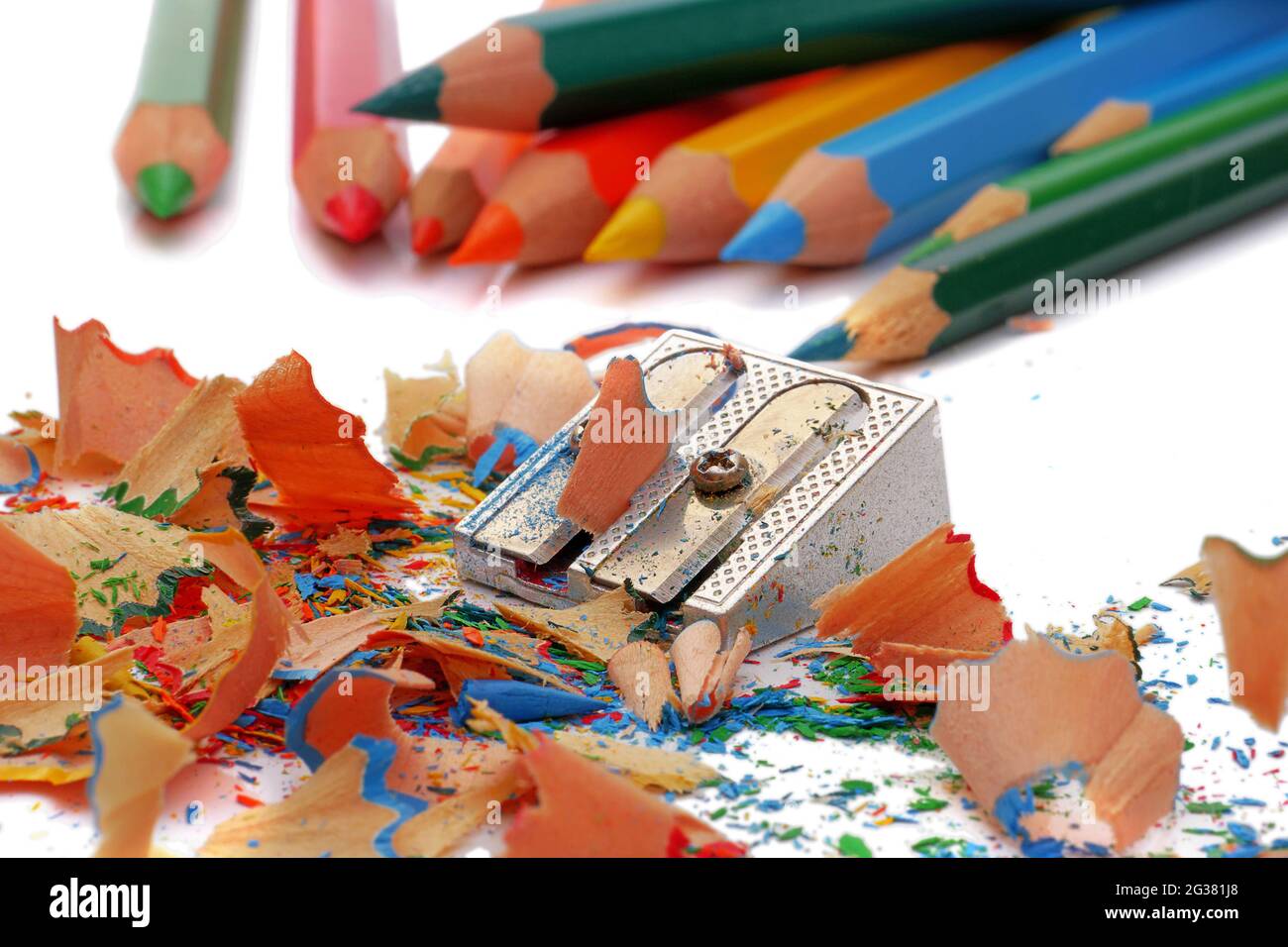 Top view of colored pencils with shavings and pencil sharpener over white  background. top view Stock Photo - Alamy