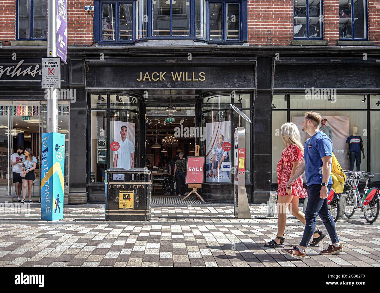 Shoppers walk past Jack Wills fashion Store on Arthur Street Stock