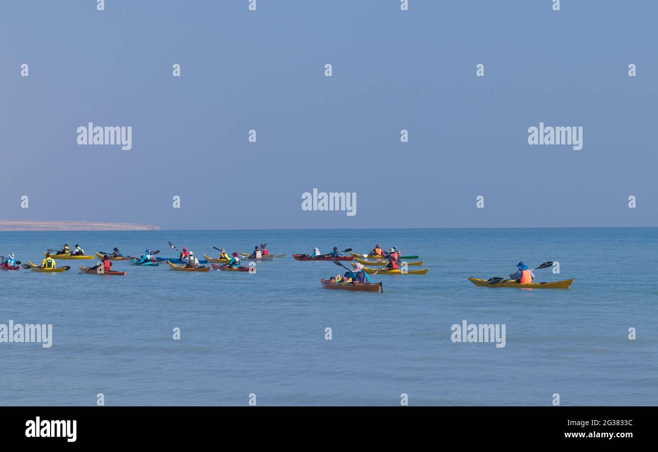 ein gedi- israel. 10-02-2021. A group of people rowing for sports in paddle boats in the Dead Sea beach Stock Photo