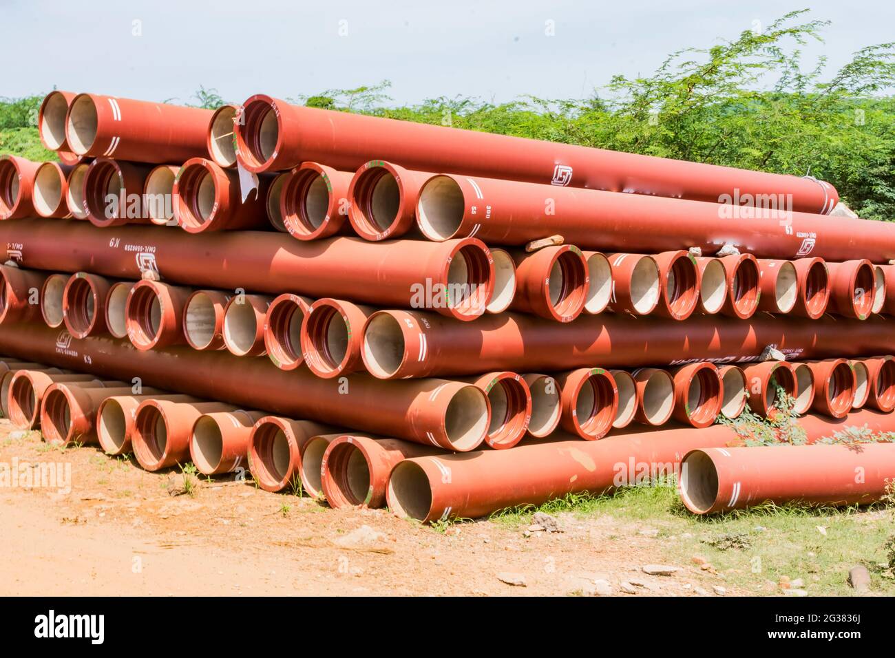 ductile iron pipes stocked in open space of a rural village store yard. Stock Photo