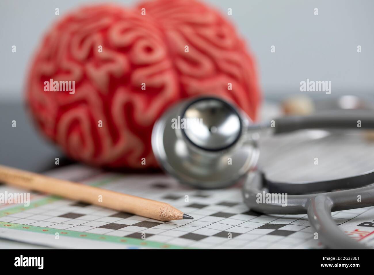 Alzheimer and brain training concept, Brain and crossword Puzzle with pencil Stock Photo