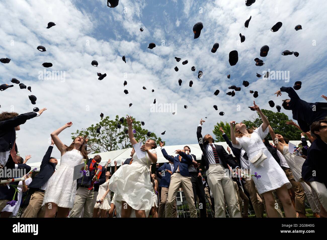American High School Graduation Ceremony throwing hats in the air Stock