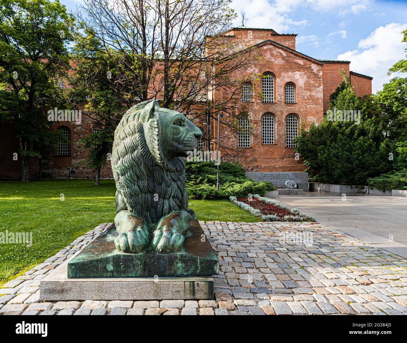 The lion as a royal symbol had disappeared for a while and now it sits crooked on its pedestal in front of the Eternal fire in memory of the Bulgarian martyrs in Sofia, Bulgaria Stock Photo