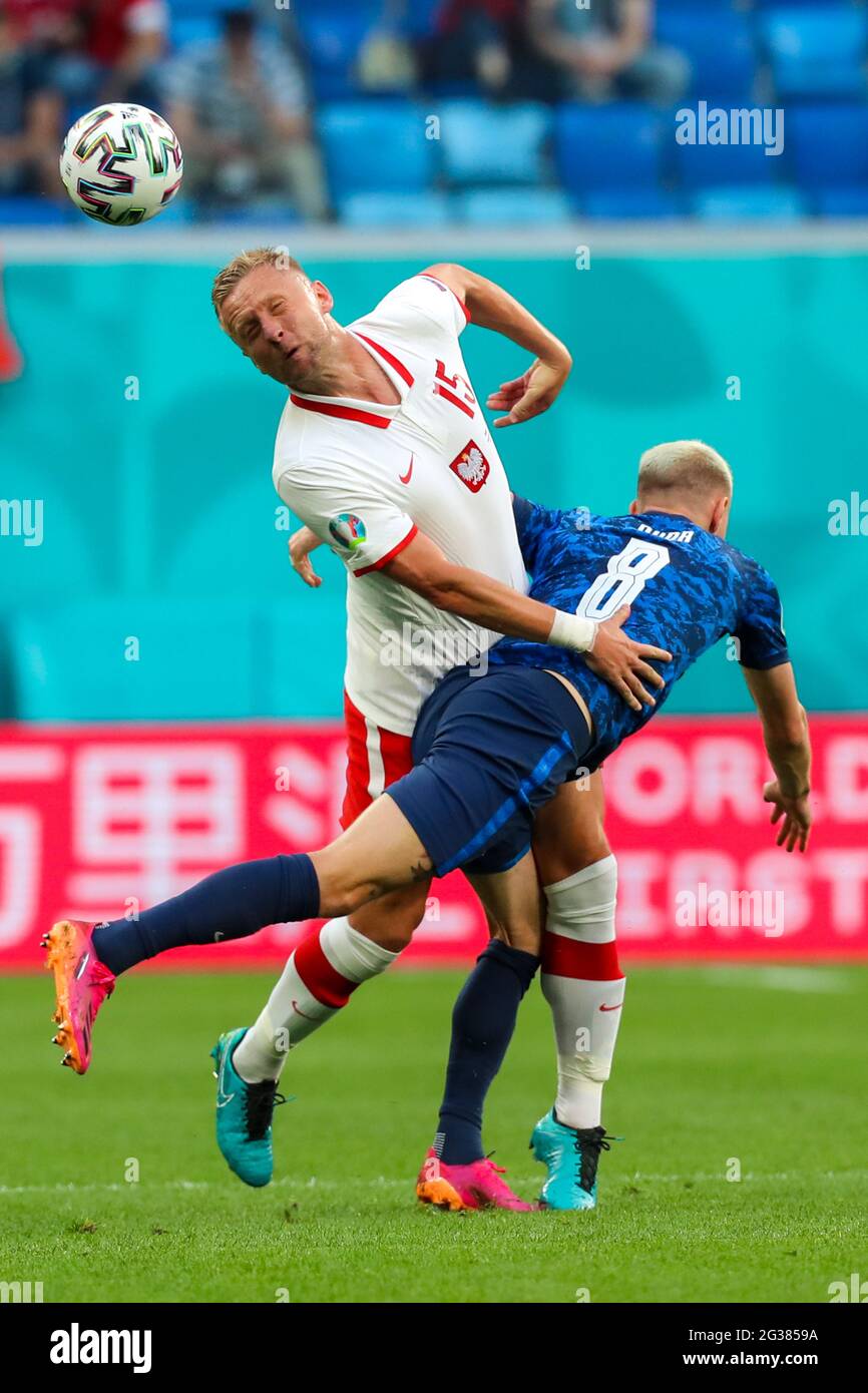 14 June 2021, Russia, St. Petersburg: Football: European Championship, Poland - Slovakia, Preliminary round, Group E, Matchday 1 at St. Petersburg Stadium. Poland's Kamil Glik (l) and Slovakia's Ondrej Duda battle for the ball.Important: For editorial news reporting purposes only. Not used for commercial or marketing purposes without prior written approval of UEFA. Images must appear as still images and must not emulate match action video footage. Photographs published in online publications (whether via the Internet or otherwise) shall have an interval of at least 20 seconds between the posti Stock Photo