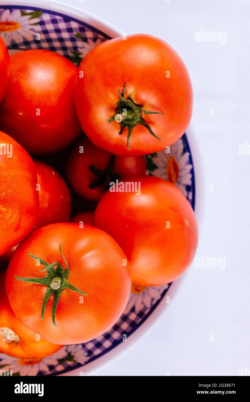 Tomatoes from organic plantation in bowl. The tomato is the edible berry of the plant Solanum lycopersicum, commonly known as a tomato plant. Andaluci Stock Photo