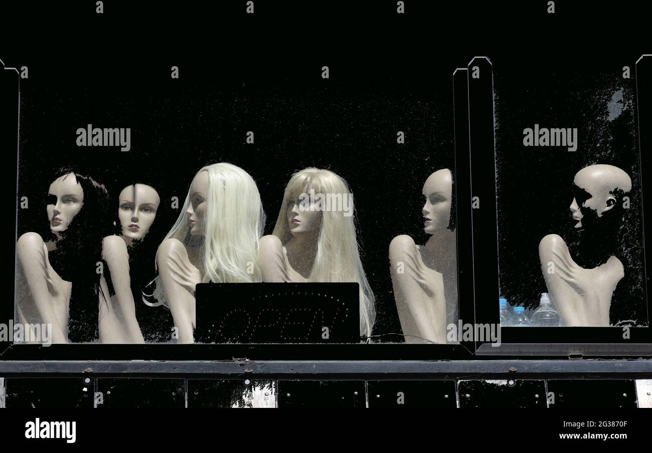 Art impression of mannequin dolls looking out of a window in England, UK. Stock Photo