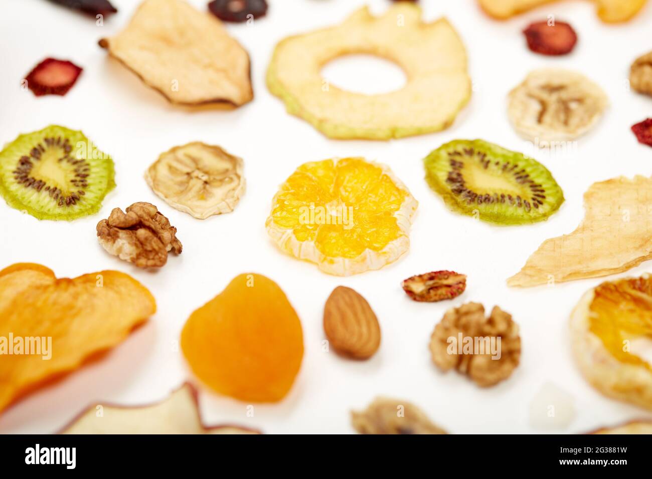 https://c8.alamy.com/comp/2G3881W/close-up-of-healthy-food-dried-apples-orange-dried-apricots-kiwi-dried-coconut-and-walnuts-on-white-background-concept-of-proper-nutrition-with-tasty-of-dried-fruits-and-nuts-2G3881W.jpg