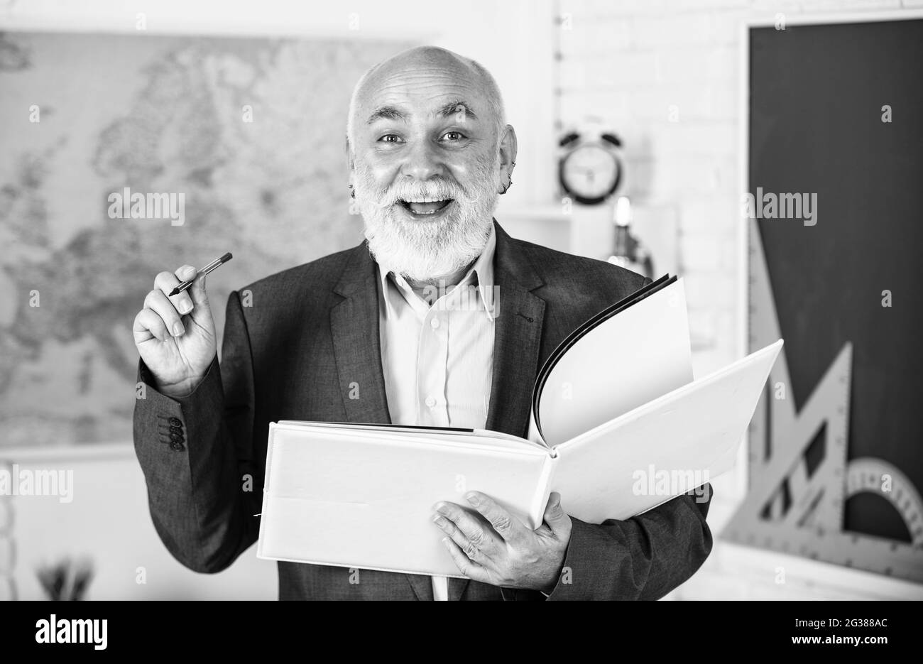 good idea to study. back to school. math education in school. bearded man give marks. write notes in book. happy senior lecturer make notes. teacher Stock Photo