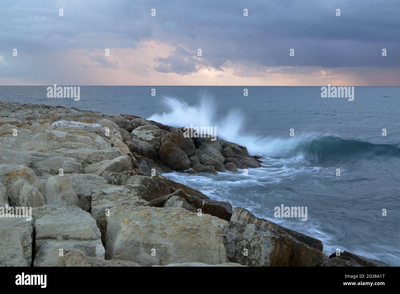 Seascape with wave splasing on the rocks, storm, horizon, cloudy sky, Stock Photo