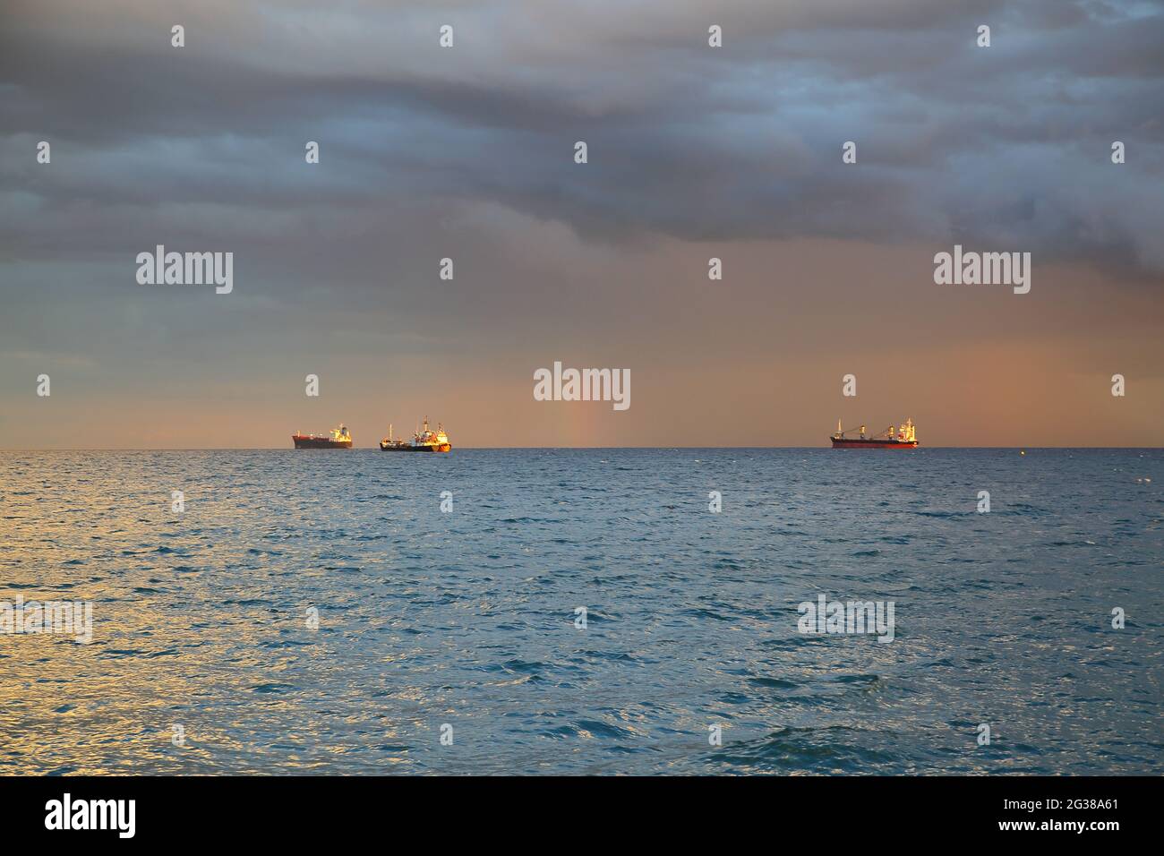 Mediterranean sea, three ships on horizon, heavy swirling clouds in teh sky Stock Photo
