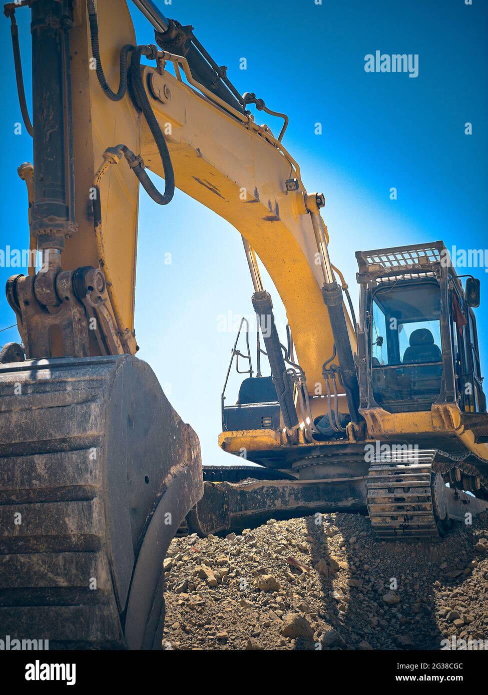 Premium Photo  Excavator and bulldozer loader with a big bucket closeup on  a blue industrial background construction equipment for earthworks rental  of construction equipment