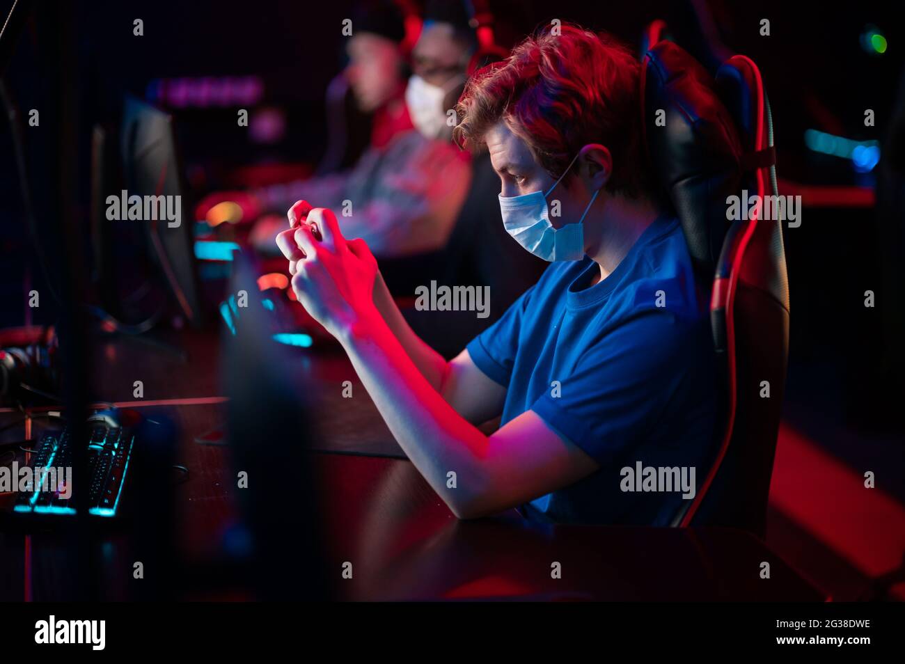 During the covid-19 pandemic, a caucasian guy plays racing on his smartphone. Stock Photo