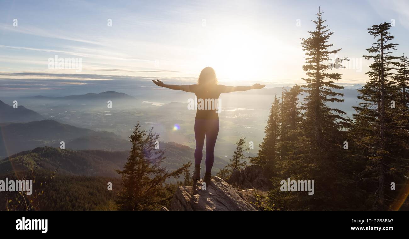 Adventurous Caucasian Adult Woman hiking in Canadian Nature Stock Photo