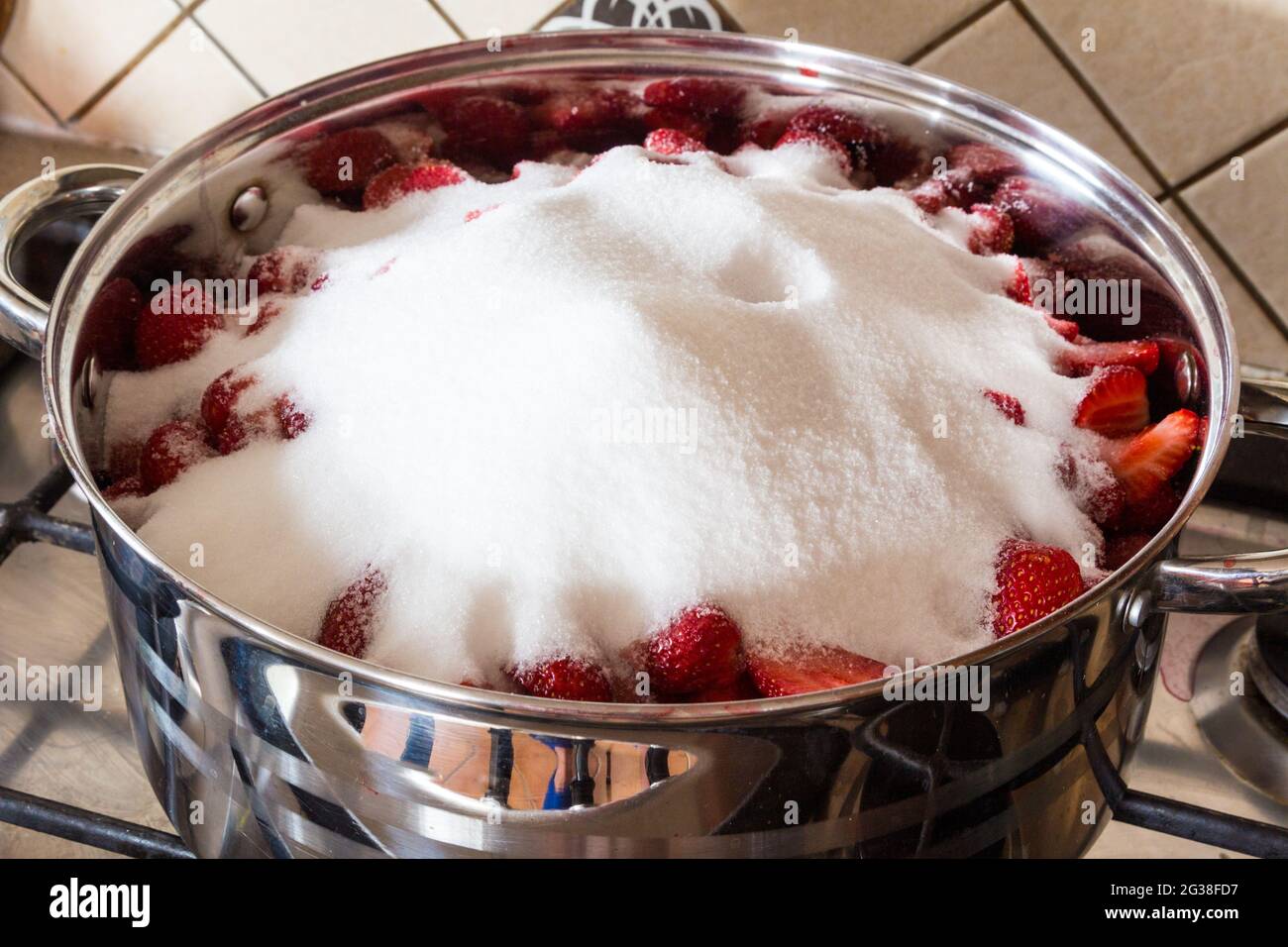 Making strawberry jam at home heap of erythritol on fruit in