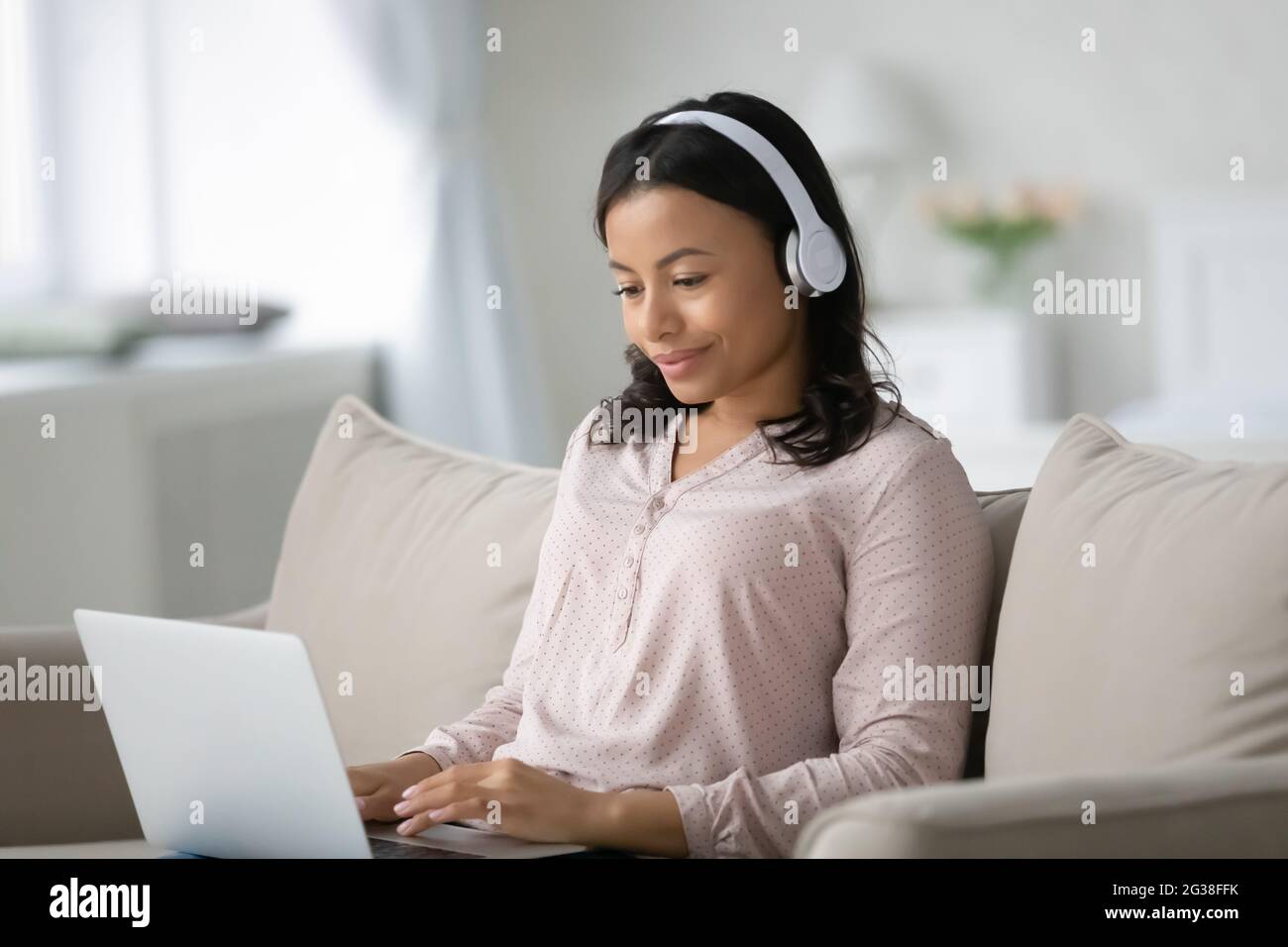 Happy African American student wearing wireless headphones Stock Photo ...