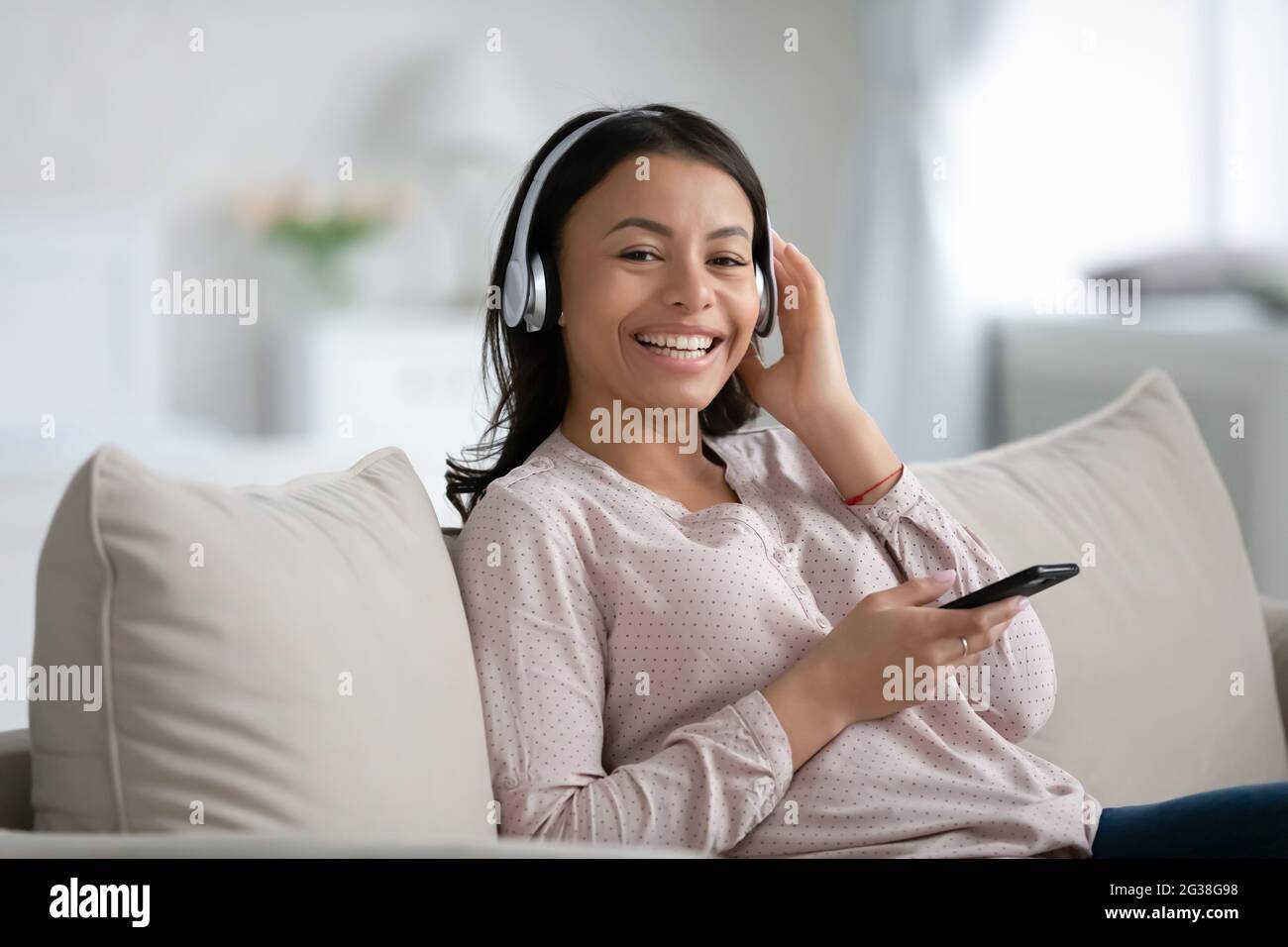 Happy African American woman in wireless headphones Stock Photo - Alamy